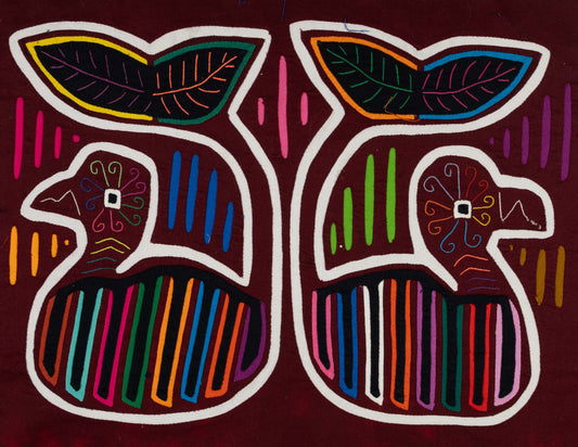 Hand-stitched Panama mola tapestry of a maroon and white whale, colorful folk-art fabric wall hanging