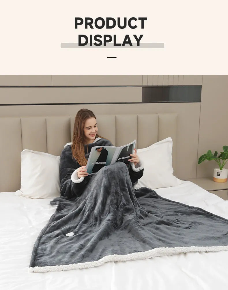 Person reading while wrapped in heated throw blanket with sleeves