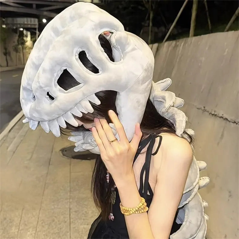 Person wearing a large dinosaur skull costume outdoors.
