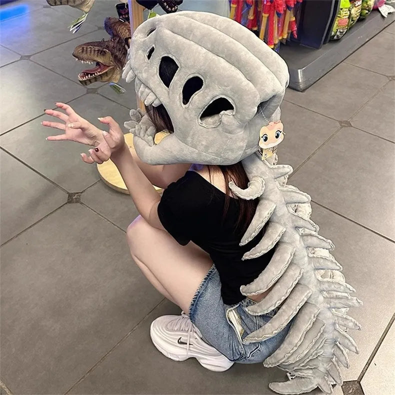 Person wearing a large white dinosaur skeleton costume in an indoor setting