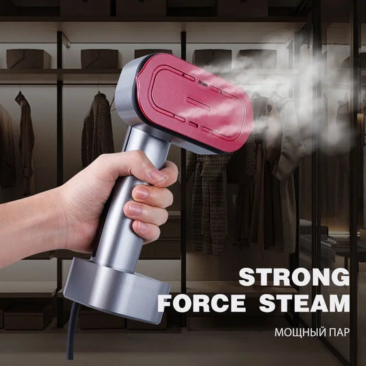 Pink handheld garment steamer producing strong force steam for wrinkle removal on hanging clothes in closet