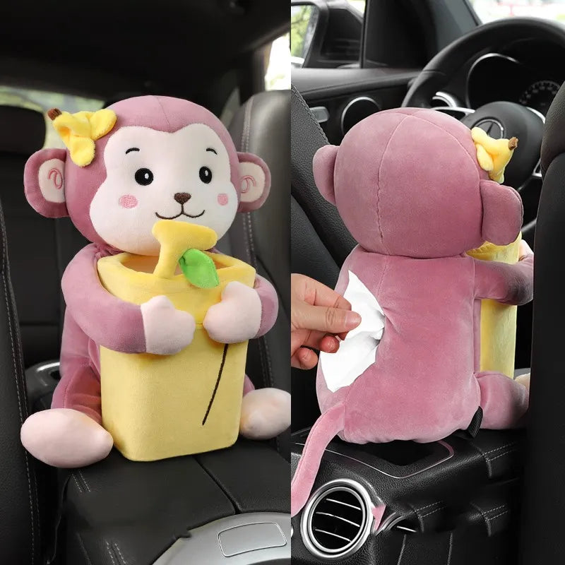 Plush monkey toy with tissue holder in a car