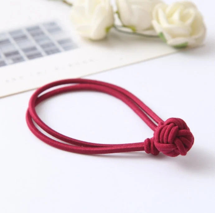 Red hair tie elastic band stretchy fabric hair accessory with decorative knot