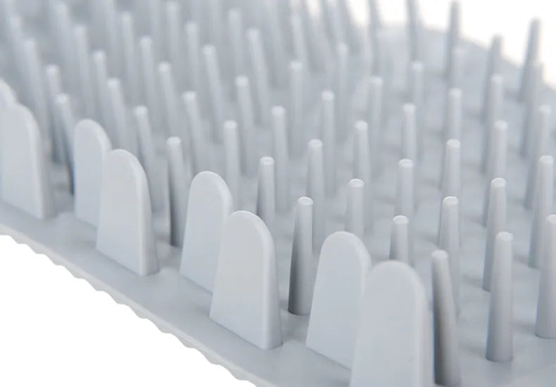 Removable silicone comb insert from portable pet paw cleaner showing easy cleaning design