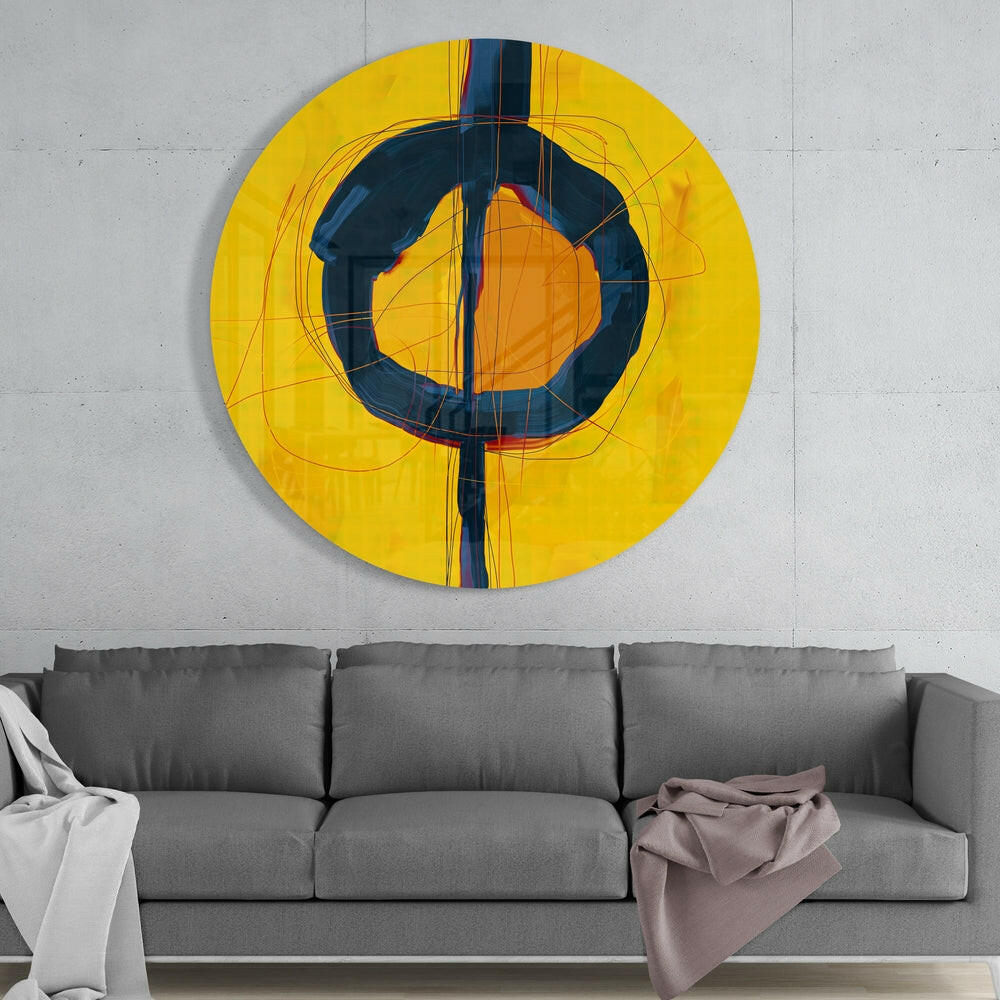Navy and yellow abstract round glass wall art above a gray sofa with white and mauve throws