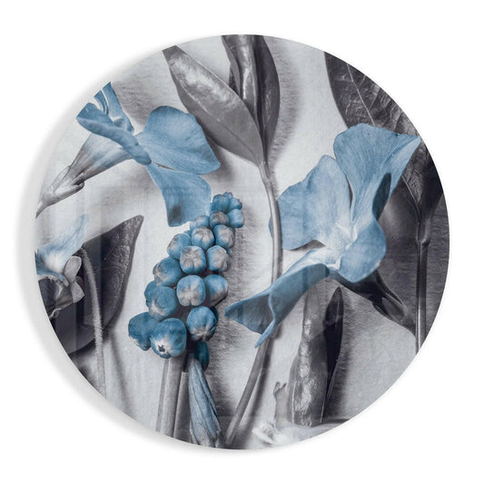 Round glass disc with steel blue blossoms and round berries among large silver gray leaves