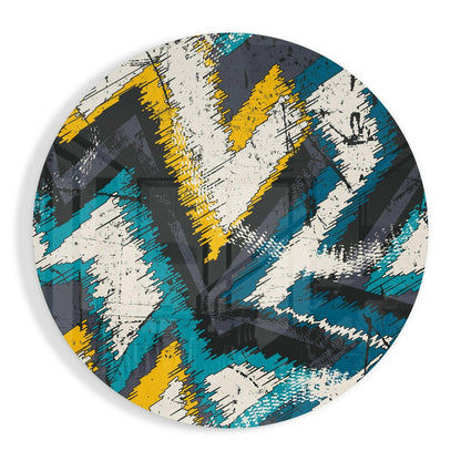 Round glass wall art of rough teal, yellow, cream and charcoal zigzag stripes with a distressed look
