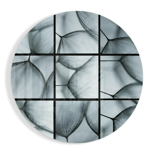 Pale blue-gray dandelion seeds in close-up divided by a black window grid, round glass wall art