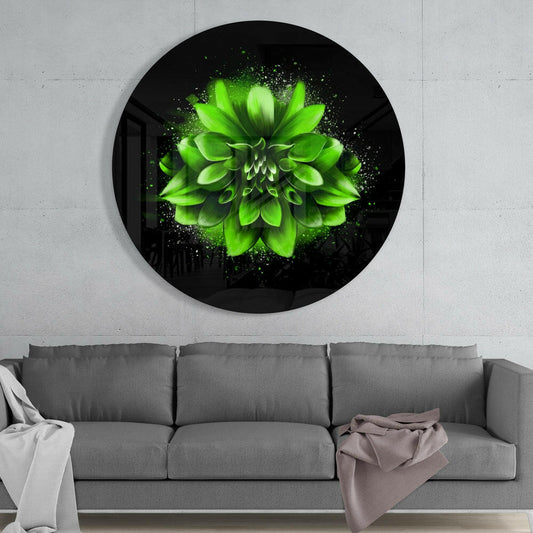 Green splatter dahlia round glass wall art above a gray sofa with a white throw and a mauve blanket on a pale concrete wall