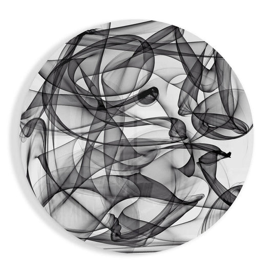 Black wisps of smoke curling in loops across a white circle, round glass wall art