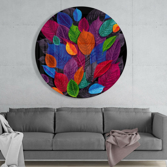 Jewel tone leaf cluster round glass wall art above a gray sofa