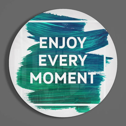 Teal brushstroke quote round glass wall art on a gray wall, showing the glossy tempered glass face