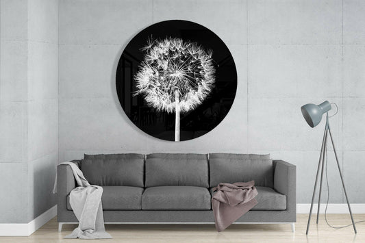 Backlit dandelion round glass wall art above a gray sofa beside a tripod floor lamp