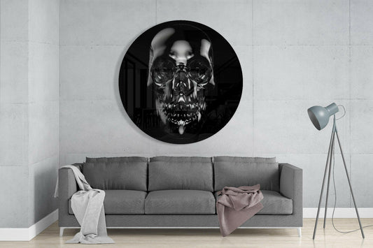 Black chrome skull round glass wall art above a gray sofa beside a tripod floor lamp