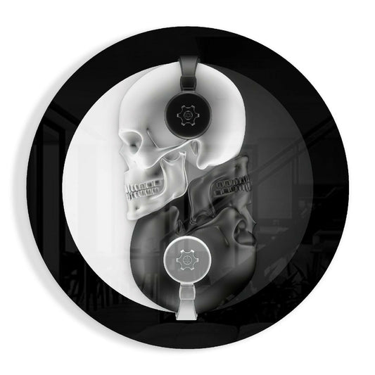Round glass disc with a white skull and a black skull forming a yin yang, sharing one pair of headphones