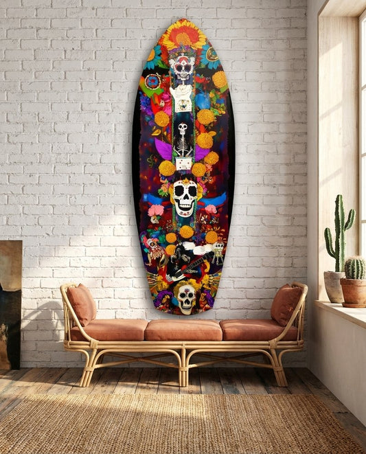 Skull totem surfboard glass wall art on a white brick wall above a terracotta daybed beside a cactus