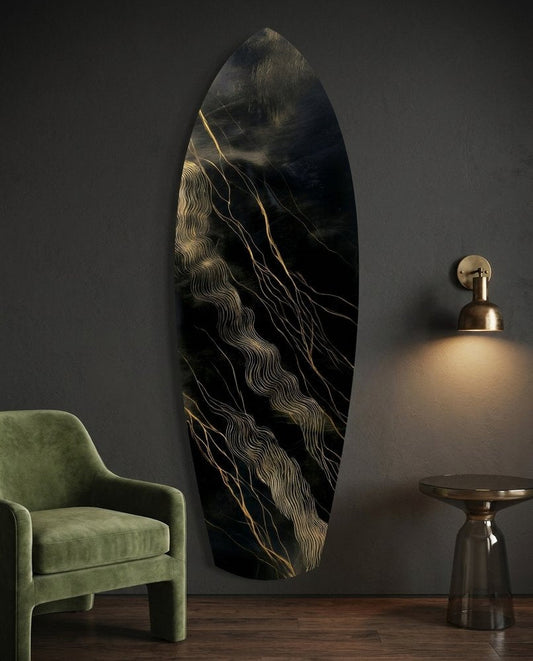 Black and gold streak surfboard glass wall art on a charcoal wall beside a green velvet armchair and a brass sconce