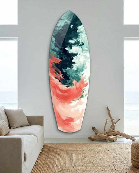 Green and Coral Abstract Waves surfboard glass wall art above a gray sofa with driftwood decor and a jute rug by tall windows