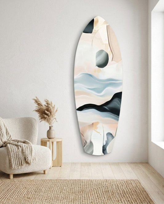 Blush and Blue Abstract Waves surfboard glass wall art in a bright white room above a cream armchair, a jute rug and a window