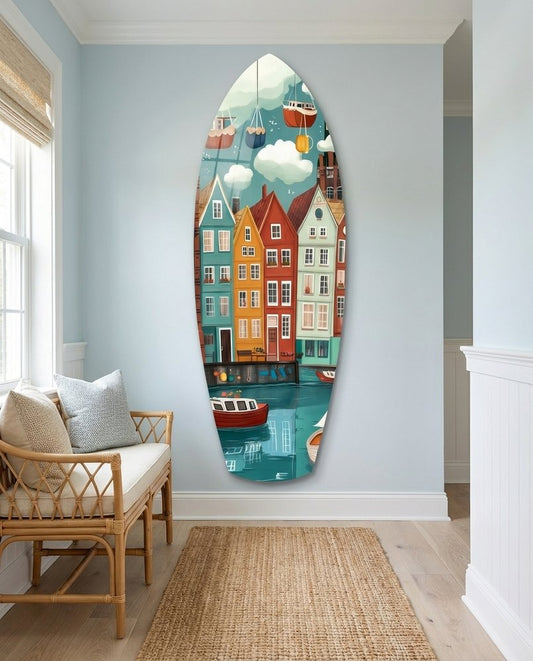 Colorful Harbor Houses and Boats surfboard glass wall art in a pale blue hallway above a rattan bench and a jute runner