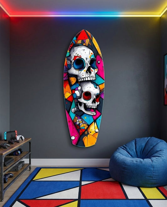 Two white skulls with blue and red eyes in a bright geometric mosaic on surfboard glass art in a game room