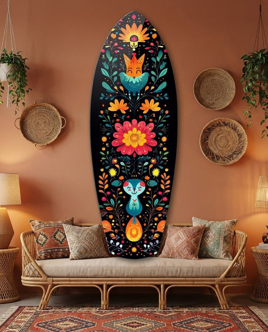Folk floral surfboard glass wall art on a terracotta wall above a rattan sofa with woven baskets and a patterned rug