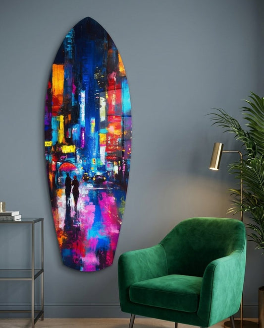 Neon city rain surfboard glass wall art beside a green velvet armchair on a blue-gray wall