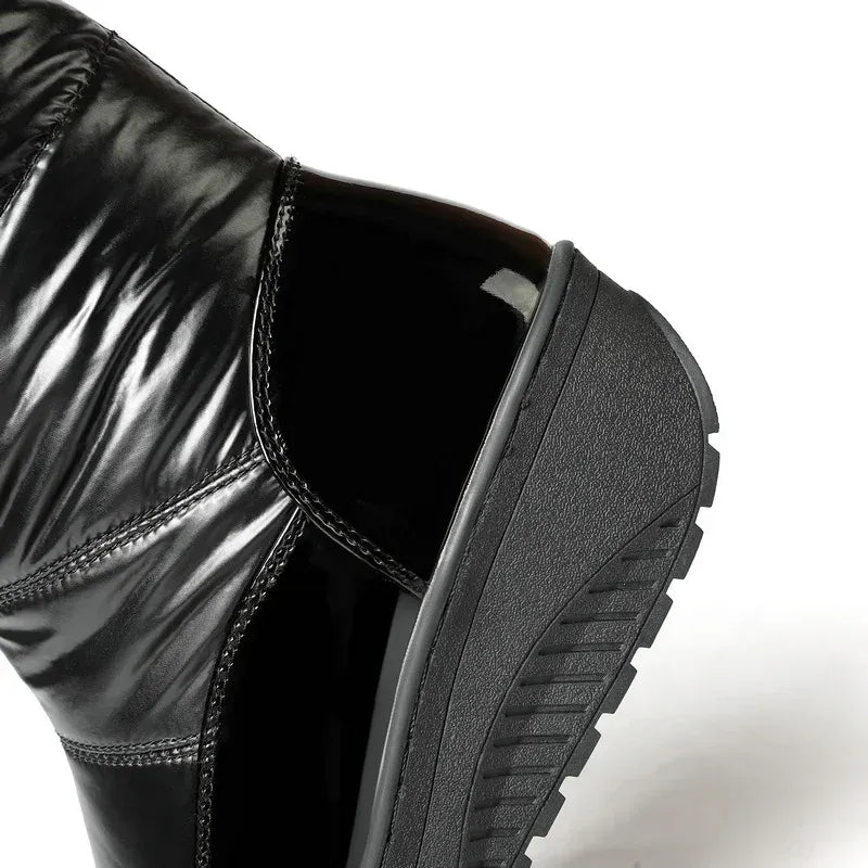 Black shiny boot with a thick sole on a white background