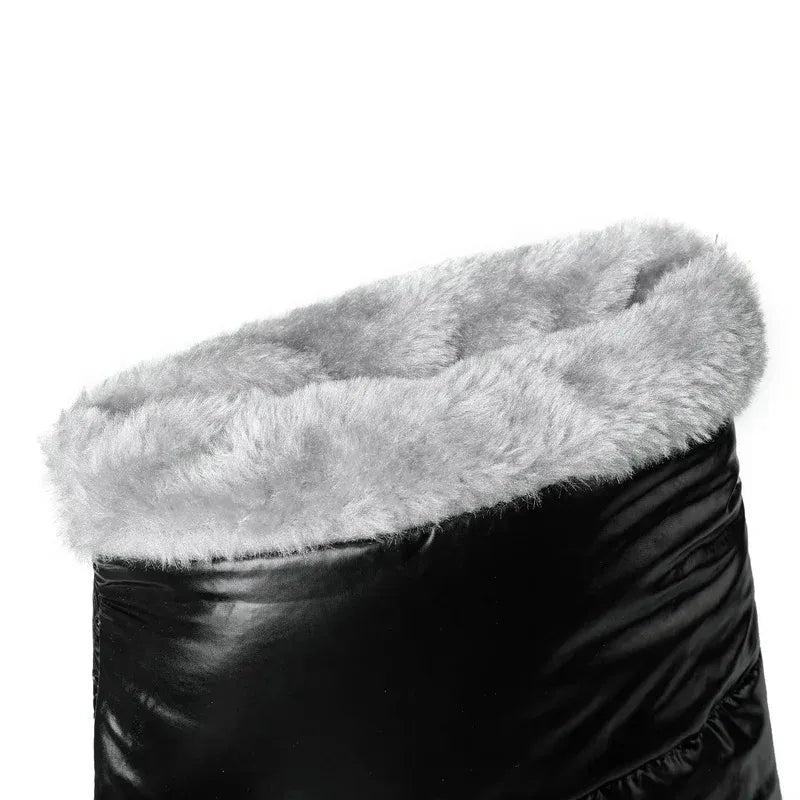Close-up of a black boot with a fluffy white lining on a white background