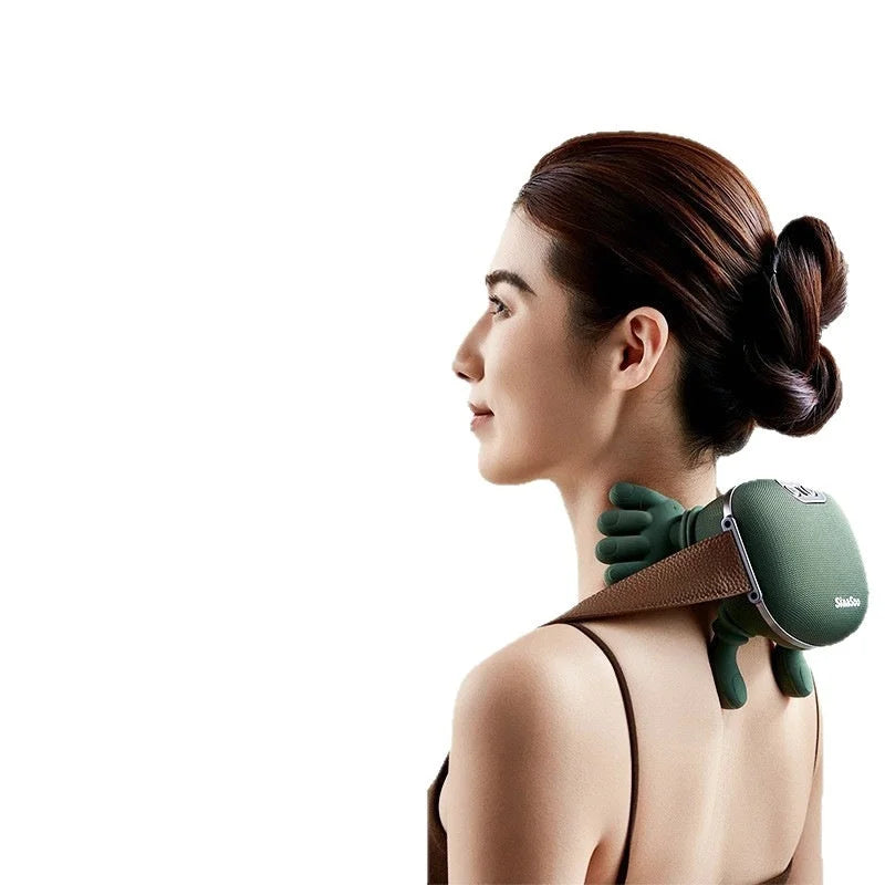 Side view of a woman using the electric massager on her shoulder for relaxation.
