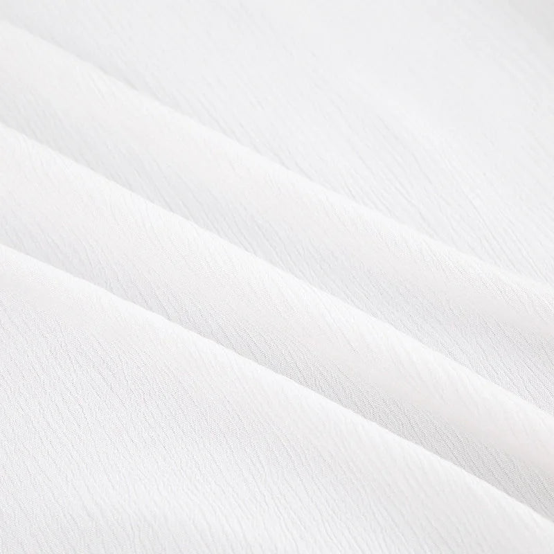 Soft white textured fabric of women's long pajama dress featuring breathable cotton-blend material