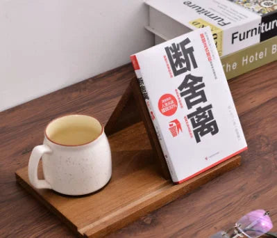 Solid wood bookmark rack holding book and coffee mug on desk