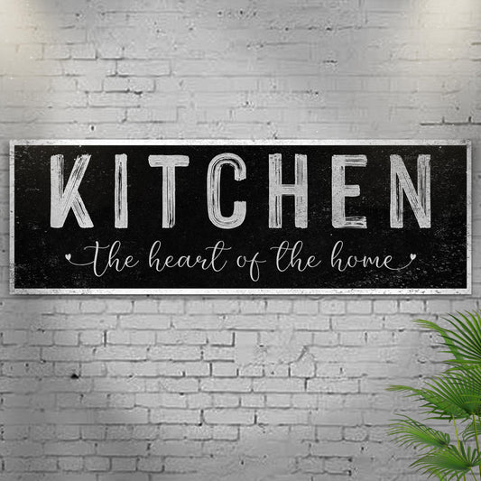 Kitchen Heart of the Home Black canvas seen at an angle on a white brick wall with leaves, view 2