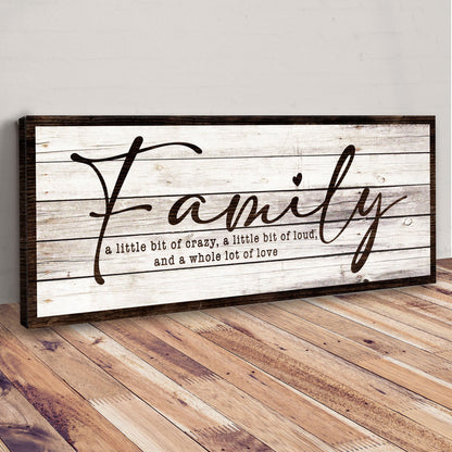 Family A Little Bit of Crazy canvas leaning against a gray wall on a wood floor, angled view