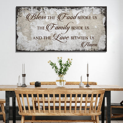 Style 2 of the Bless the Food canvas sign with a dark charcoal distressed-look edge above a dining bench