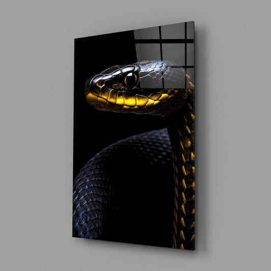 Black snake glass wall art on a gray wall, light reflecting off the glossy front