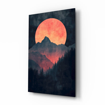 Red moon over mountains glass wall art, red-orange moon above indigo ridges and pines