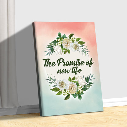 White rose wreath canvas with green lettering leaning on a wood floor against a pale gray wall