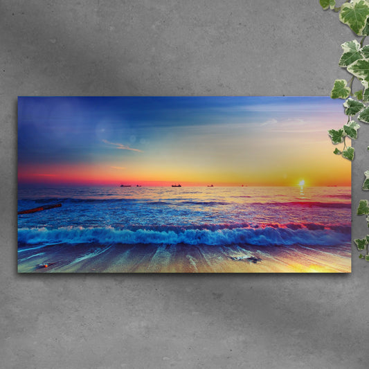 Sunrise over a calm ocean with warm gold light canvas wall art