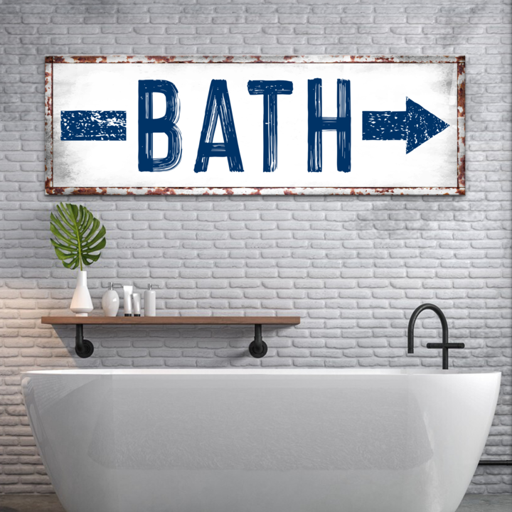 Bath arrow rustic bathroom canvas sign hanging on a wall above a tub