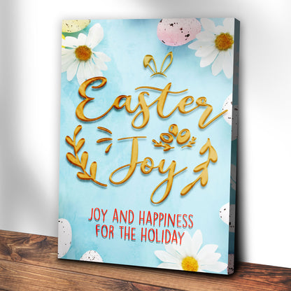 Easter Joy canvas leaning on a white wall above a dark wood floor, angled view