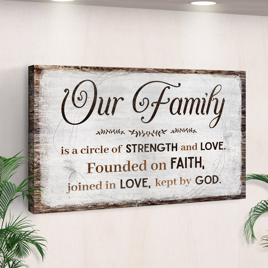 Our Family canvas sign with a saying about strength, love and faith on rustic white, seen at an angle by a palm