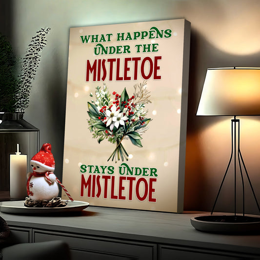 What Happens Under The Mistletoe funny holiday canvas sign with festive mistletoe typography