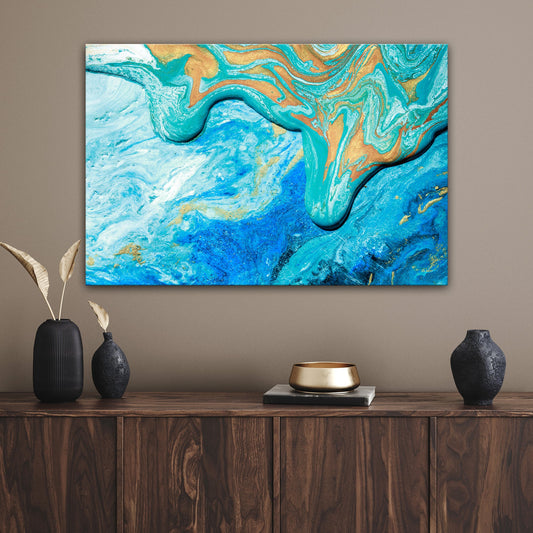 Abstract sea canvas wall art in calm blue tones hanging in a coastal living room