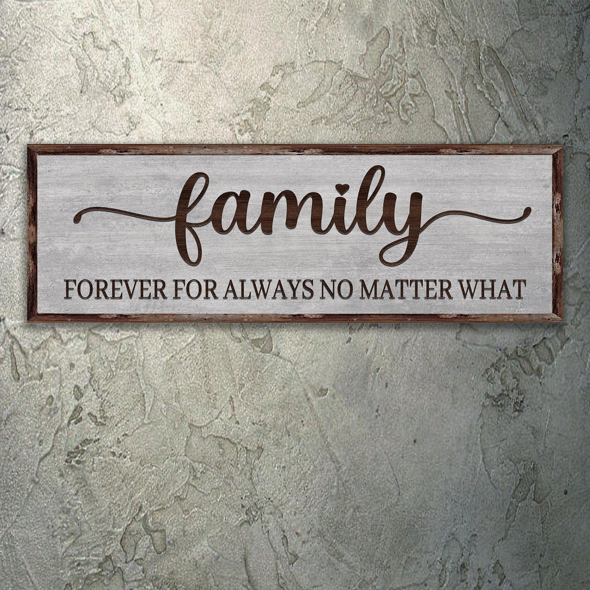 Family canvas sign with brown script on a gray wood-look background, hung on a mottled gray-green wall