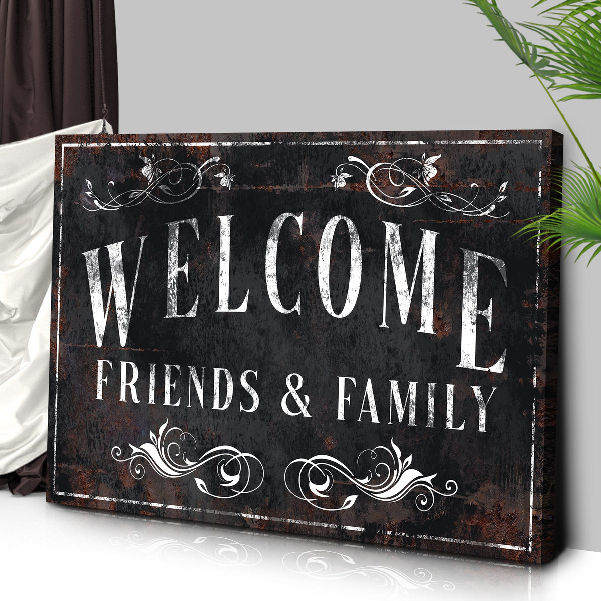 Angled close-up of the black Welcome Friends and Family canvas sign showing its wrapped edge
