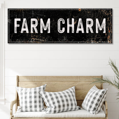 Farm Charm canvas sign in the black distressed style above a wooden bench with plaid pillows