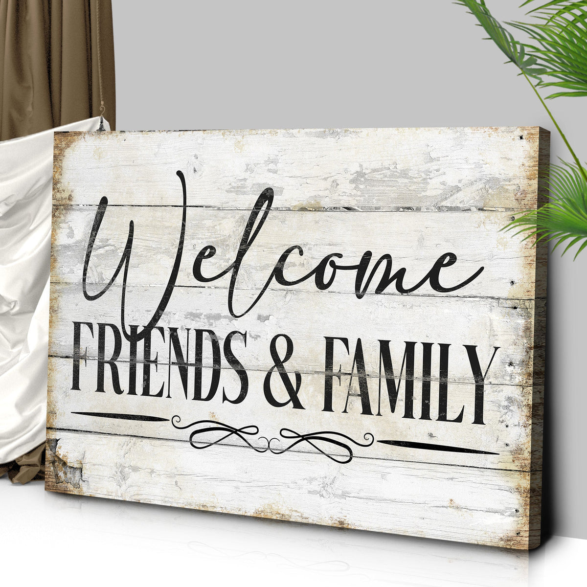 Angled close-up of the white wood-look Welcome Friends and Family canvas sign showing its wrapped edge