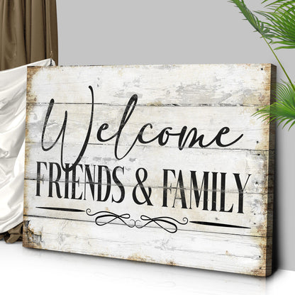 Angled close-up of the white wood-look Welcome Friends and Family canvas sign showing its wrapped edge