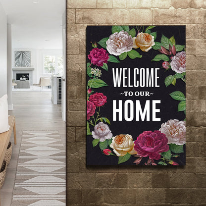 Floral Welcome to Our Home canvas sign on a stone tile wall beside a hallway